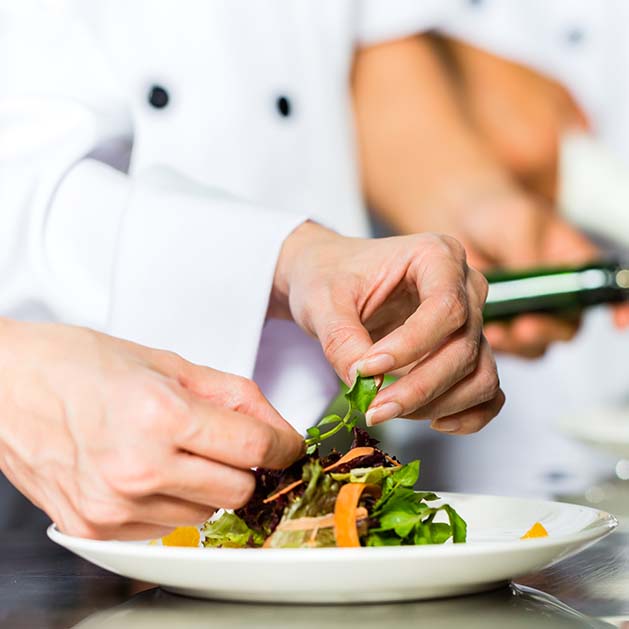Asian Chef in restaurant kitchen cooking